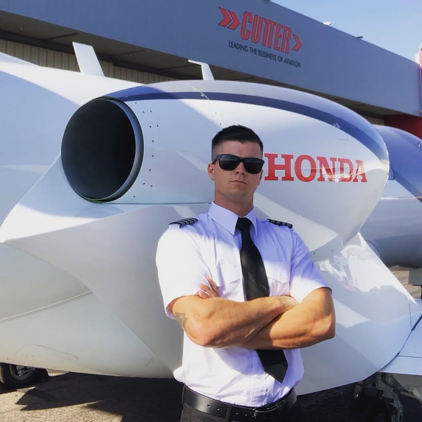 Connor beside an aircraft